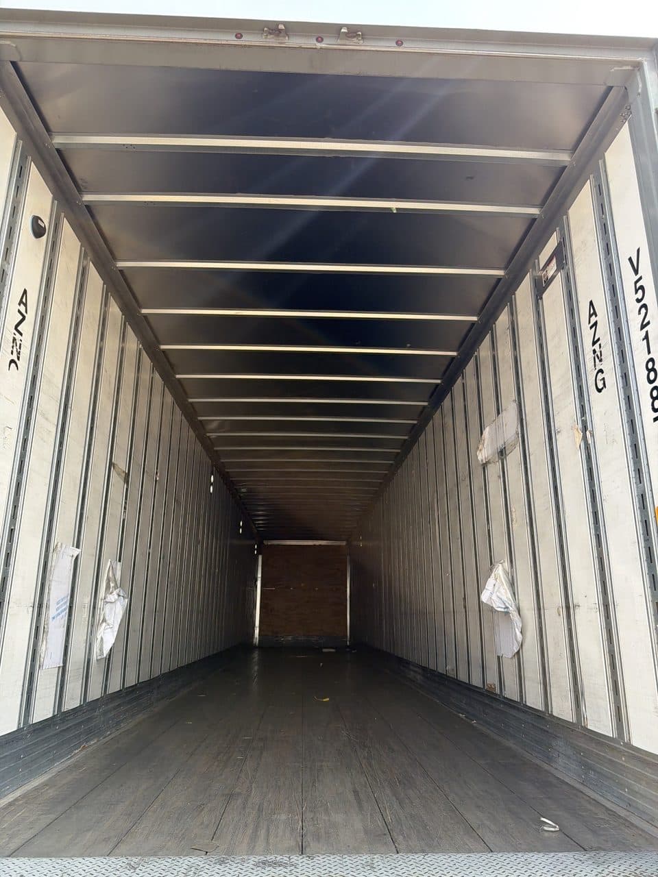 Empty trailer after unloading, photographed from the open rear doors