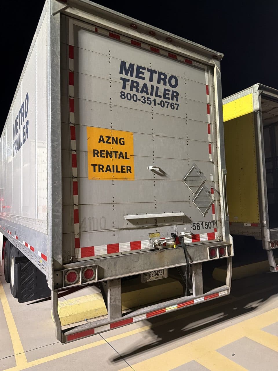 Rear doors of the loaded trailer at pickup, photographed at night
