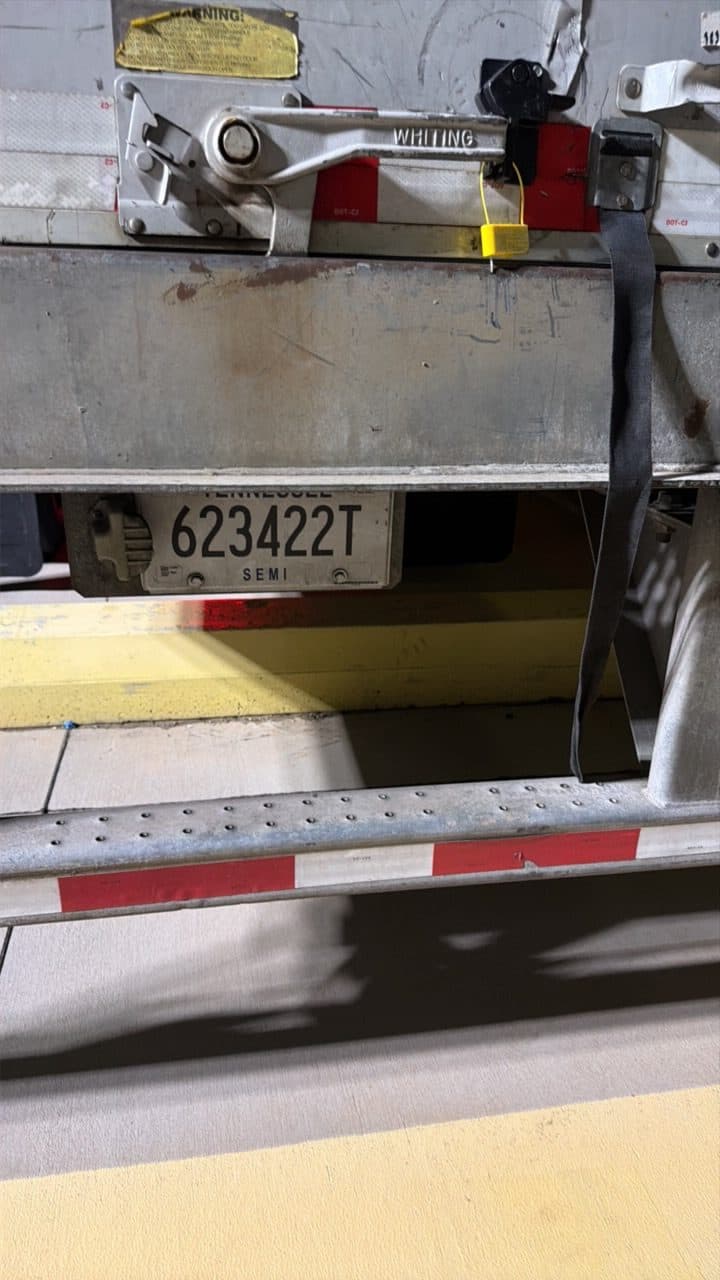 Trailer plate under the rear doors, the seal on the door latch above it